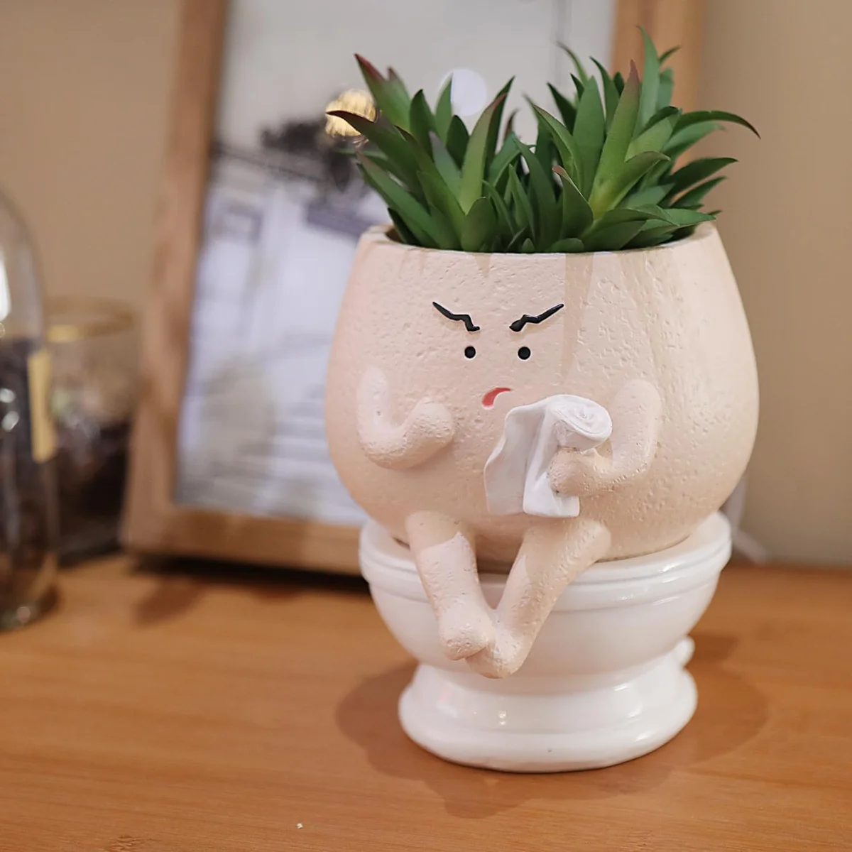 Face-shaped ceramic planter pot with quirky expression