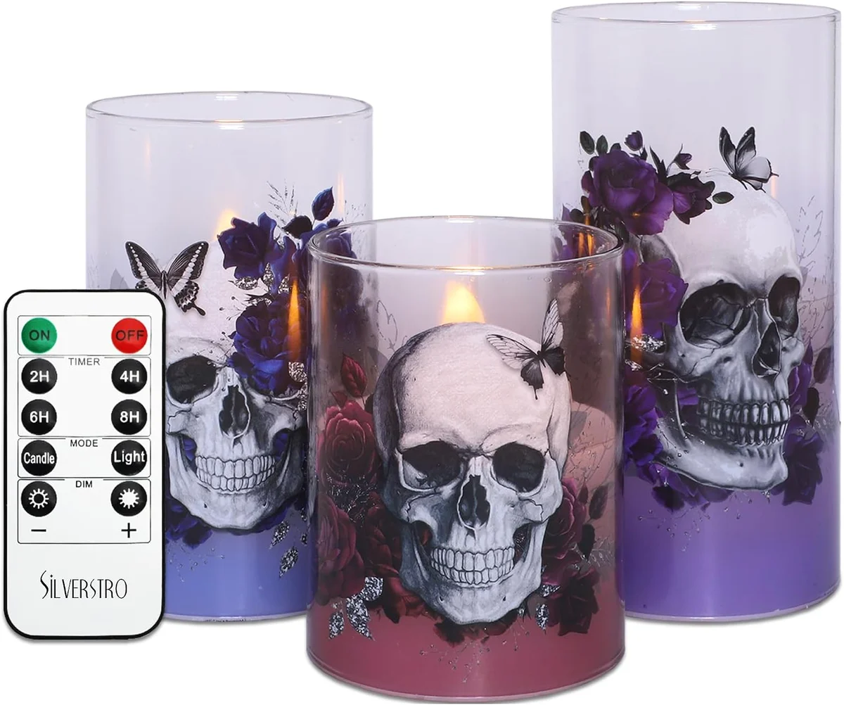 Three skull-shaped flameless candles with black remote control unit and timer function