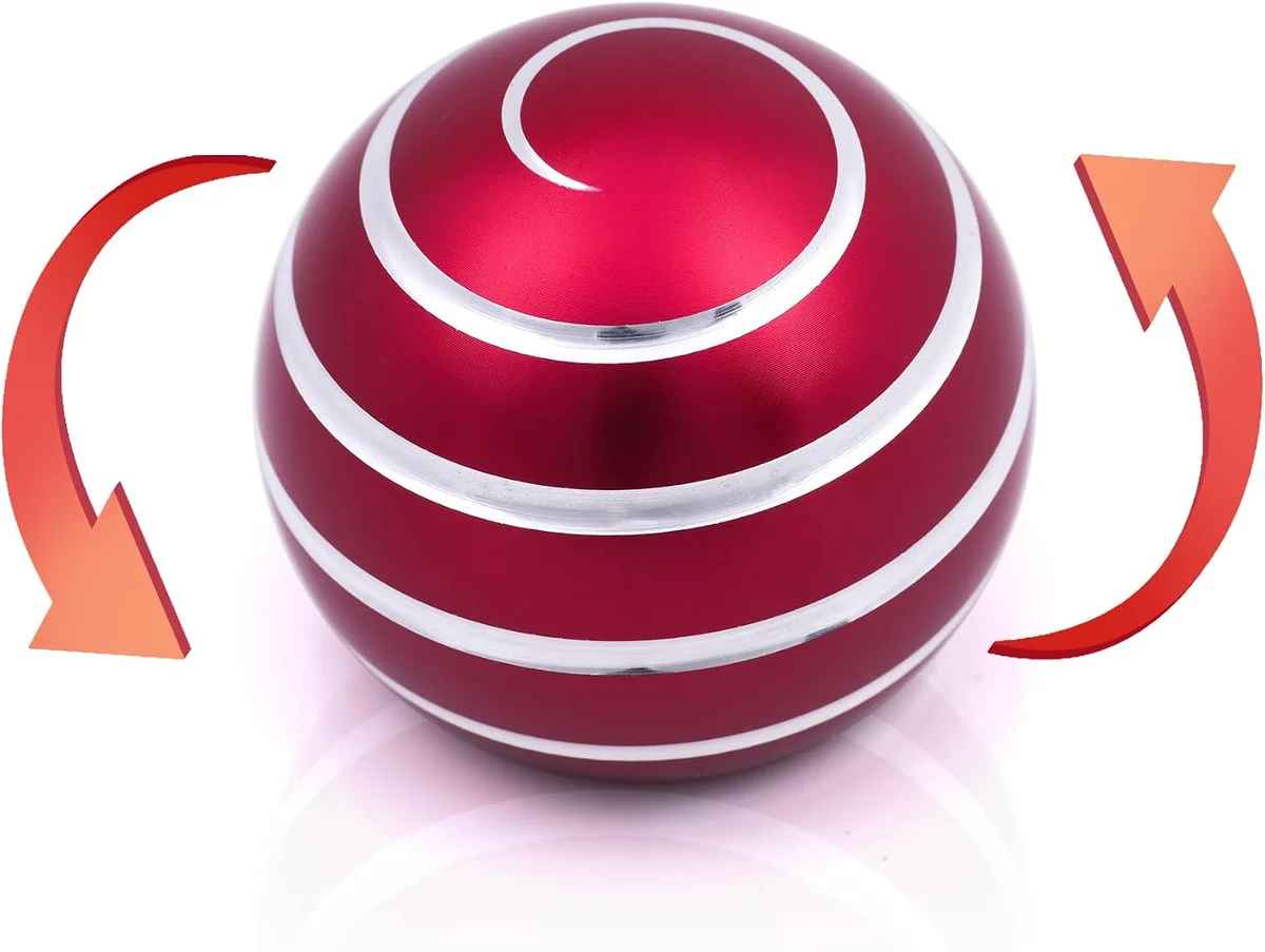 Metallic kinetic desk toy with concentric spinning rings that create a hypnotic optical-illusion pattern when flicked, sitting on a small circular base as an adult stress-relief fidget gadget