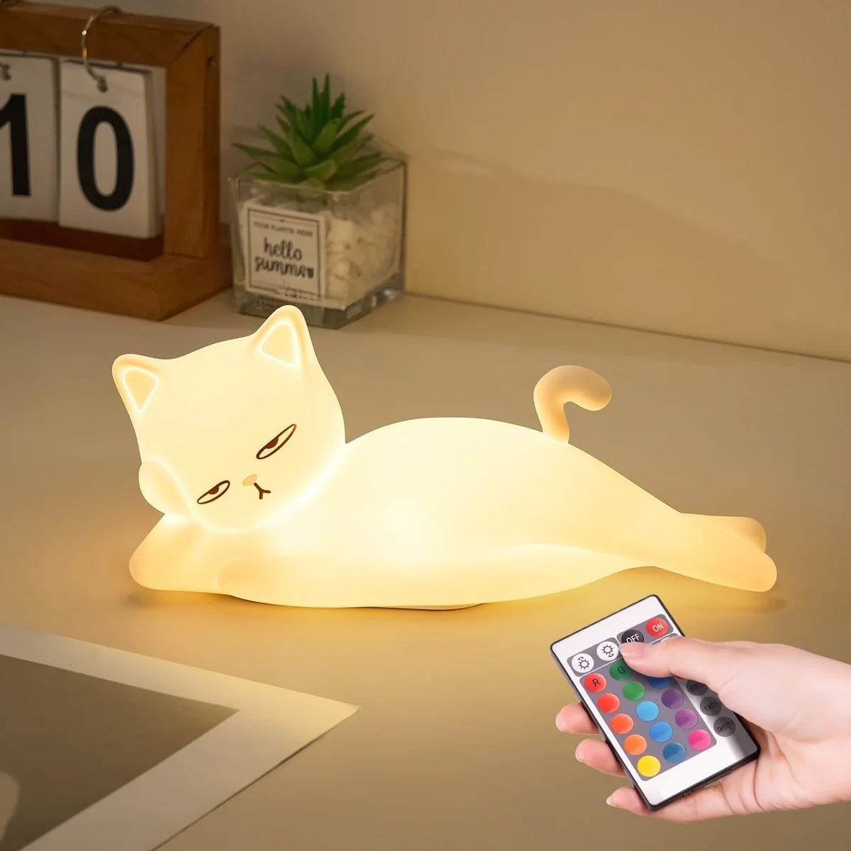 Squishy silicone cat lying flat on its belly as a color-changing night light lamp