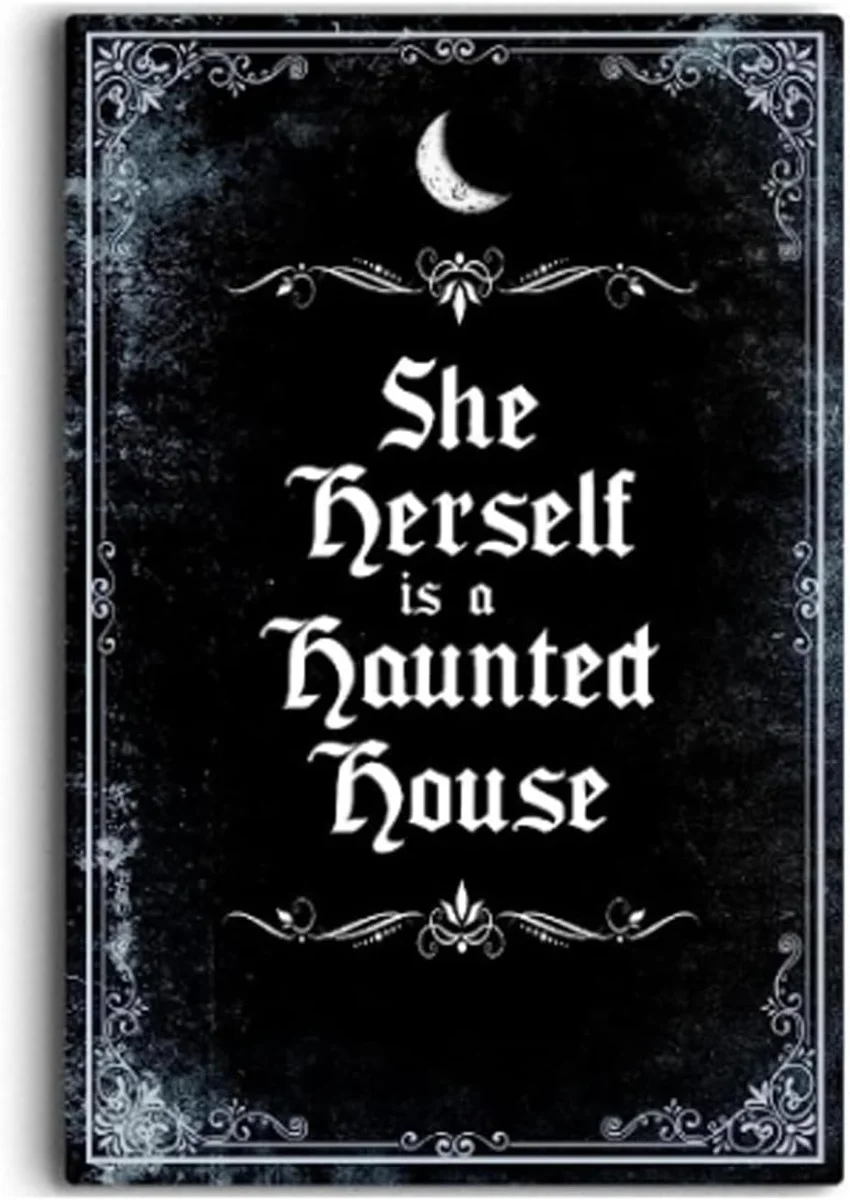 IRISIVITA vintage-style black metal wall sign printed in cream lettering with the phrase She Herself Is A Haunted House, framed with a decorative gothic border, sized 11.75 by 7.8 inches, marketed as witchy bedroom and Halloween decor