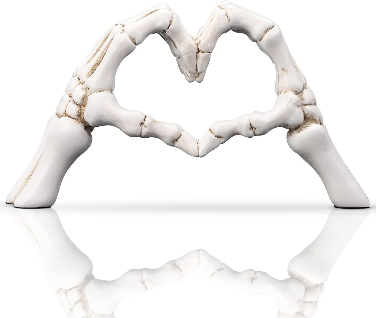 White skeleton hands forming a heart shape, ceramic figurine