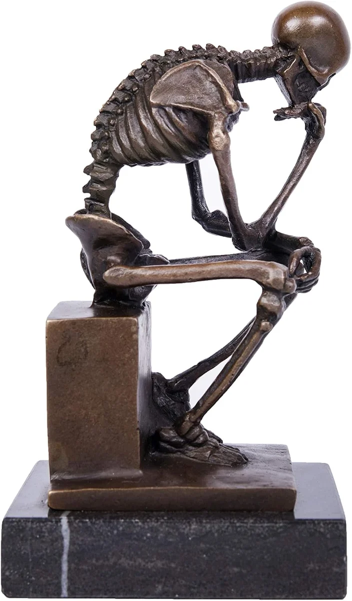 Bronze-finish resin sculpture of a full human skeleton seated on a rock in the pose of Rodin's Thinker, elbow on knee and skull resting on hand, displayed as a home decor statue